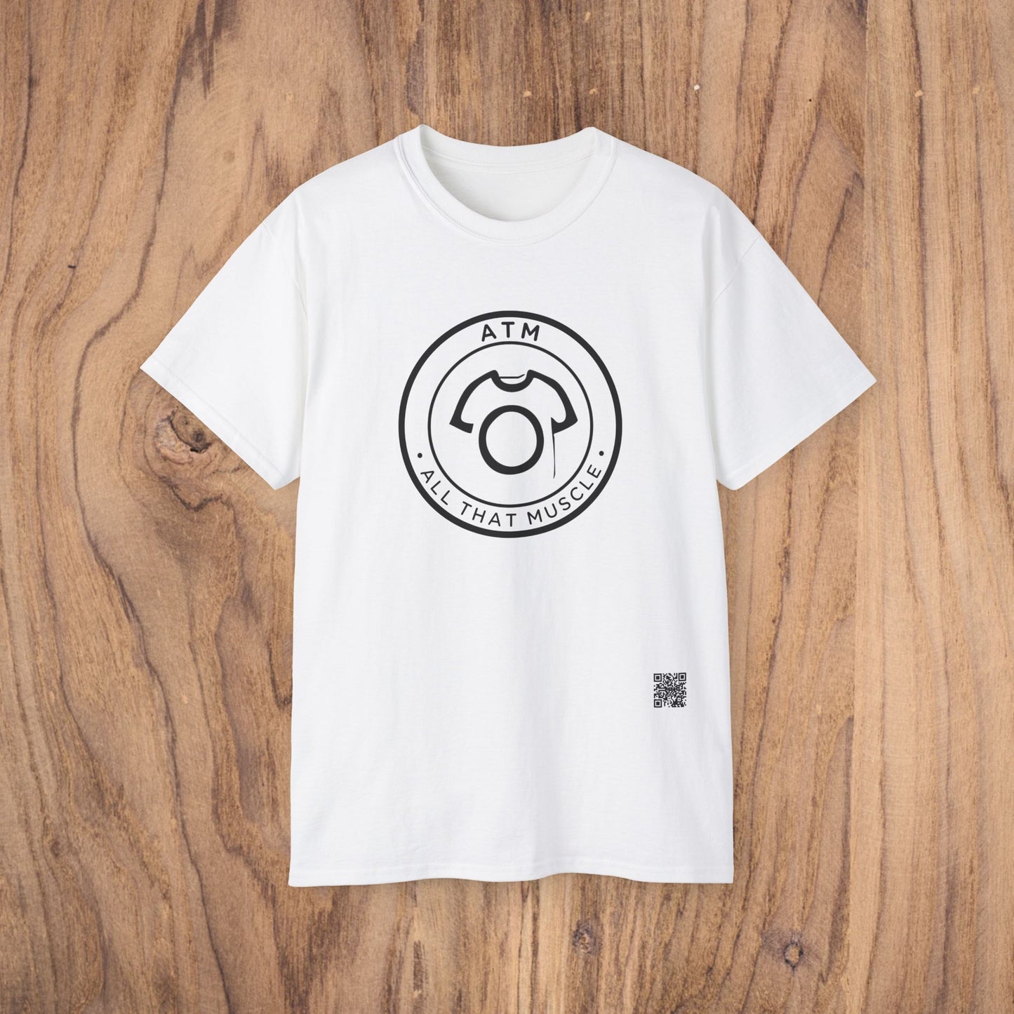 White t-shirt with black graphic design on a wooden surface