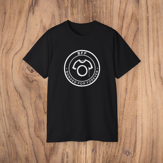 Black t-shirt with a white graphic and text on a wooden surface