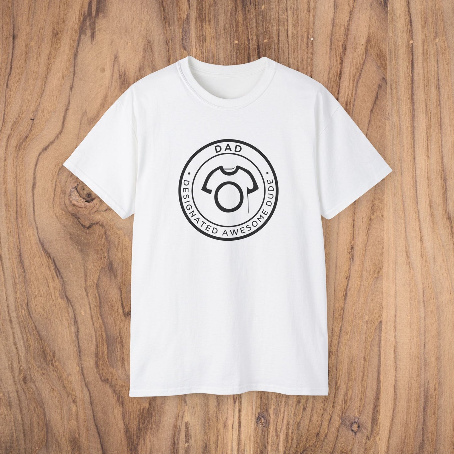 White t-shirt with a black graphic design on a wooden surface