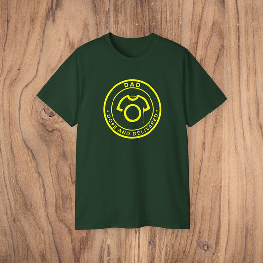 Green t-shirt with yellow graphic and text on a wooden surface